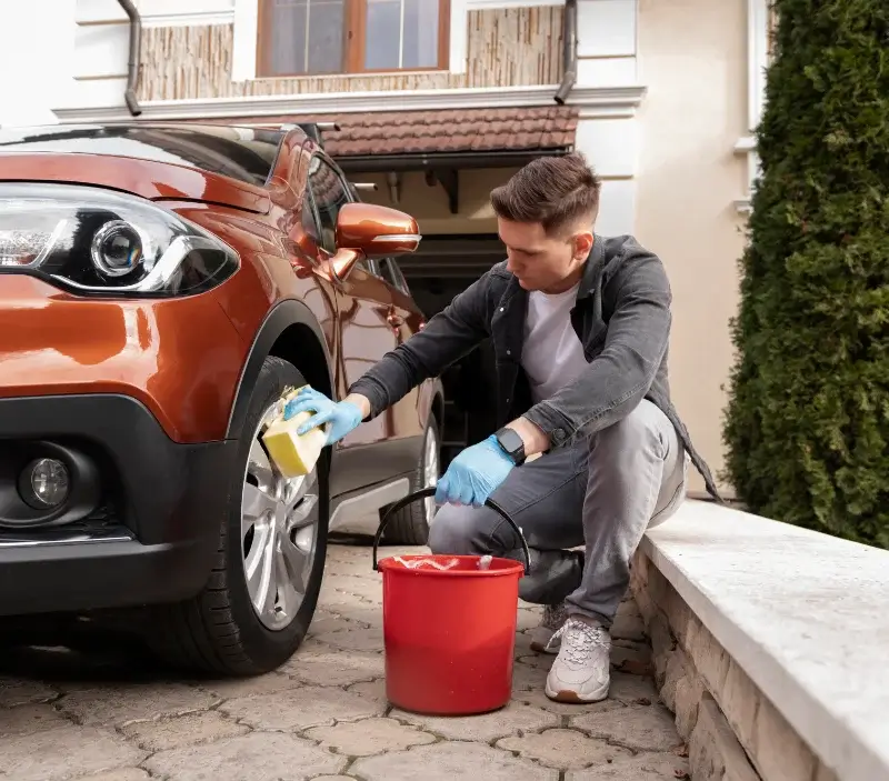Lavage auto à domicile Sainte-Féréole : professionnel intervenant sur un véhicule